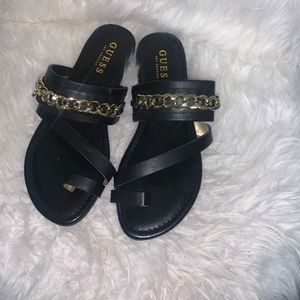 Guess black with gold chain and G charm on each sandal.Never been worn